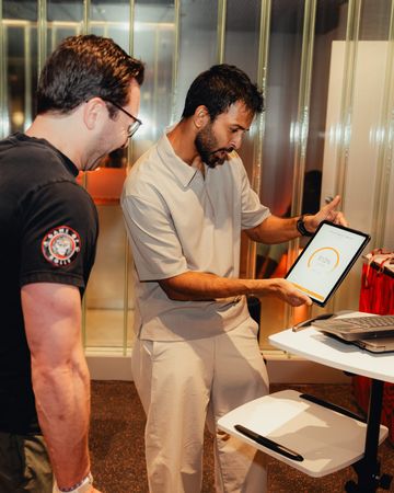 Coach going through results on a tablet with a member