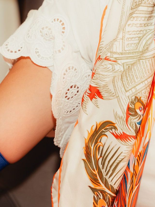 Skin of the upper arm under a white lace sleeve