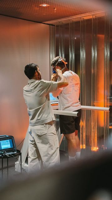 A coach fits a member with the mask for a VO₂max test